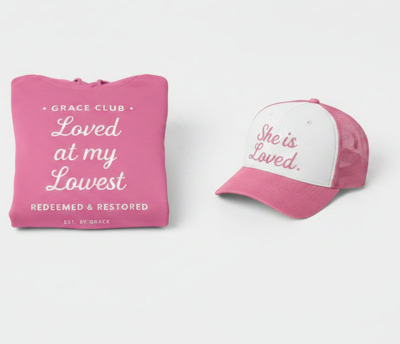 Pink hoodie and cap set with motivational text on a white background